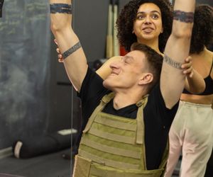 Close up of a person gripping a pull up bar